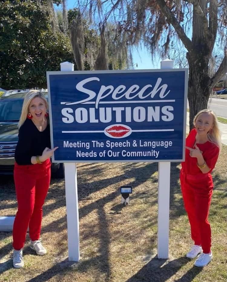 Speech Pathologists next to Speech Solutions signage